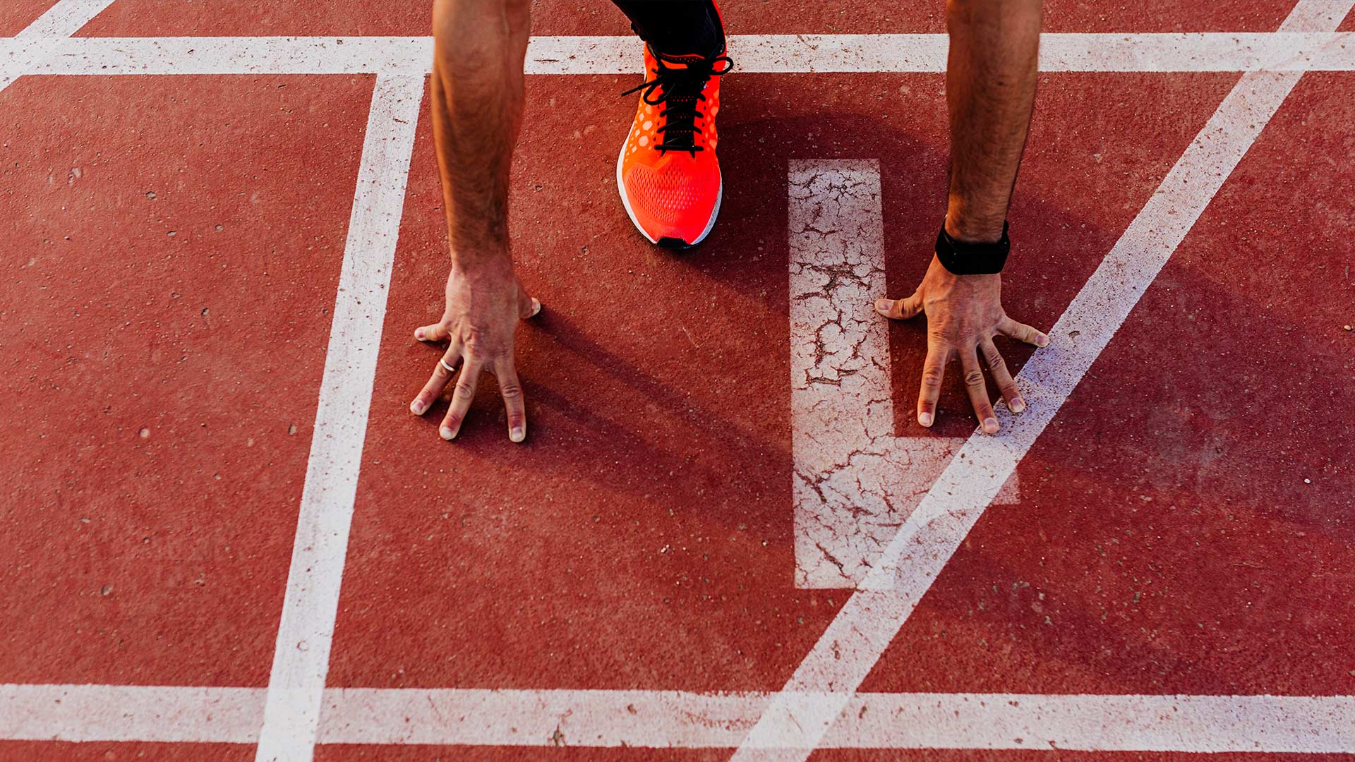 Runner in a track lane getting ready to start