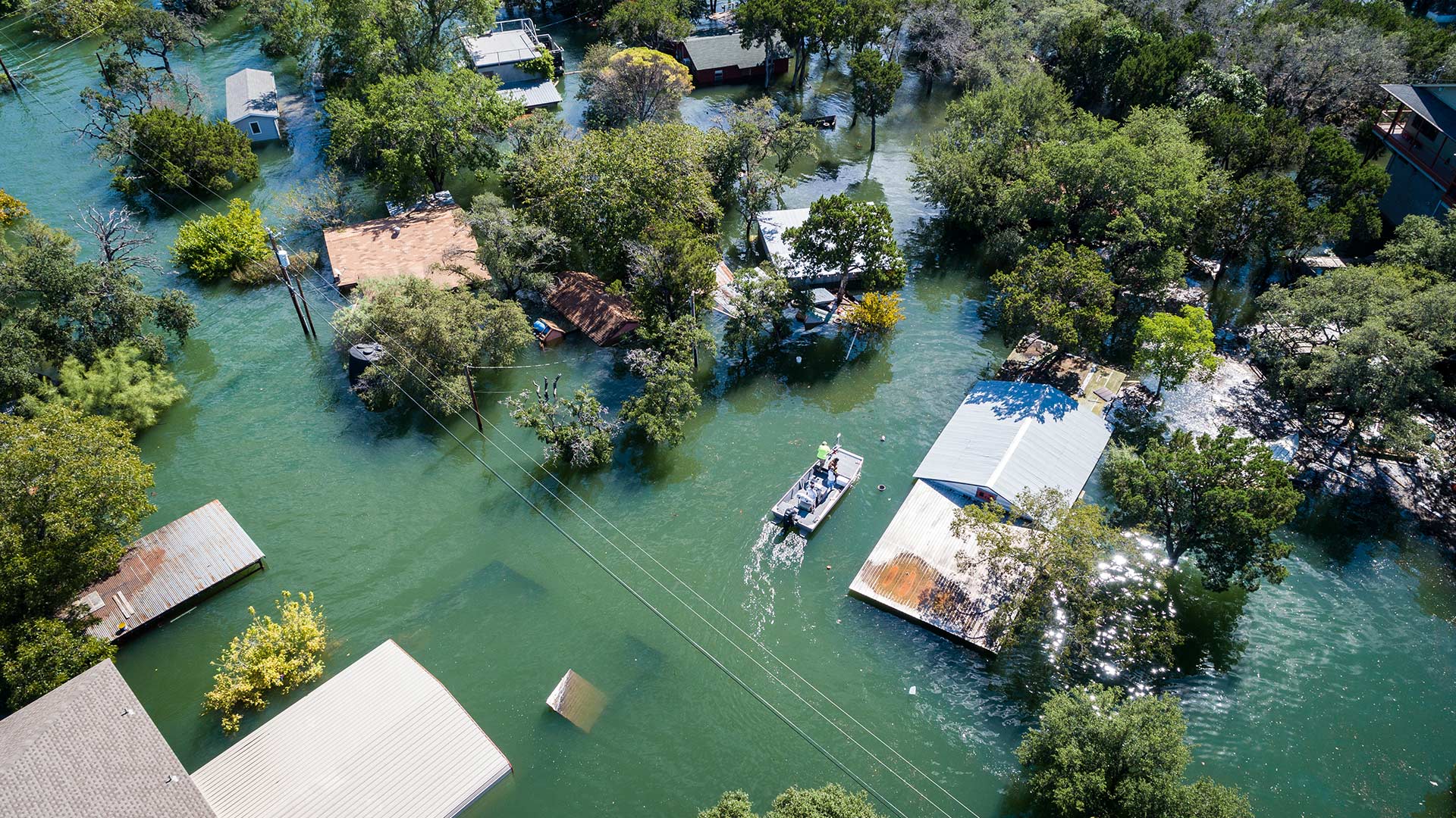 Ariel shot of a flooded neighborhood with a rescue boat