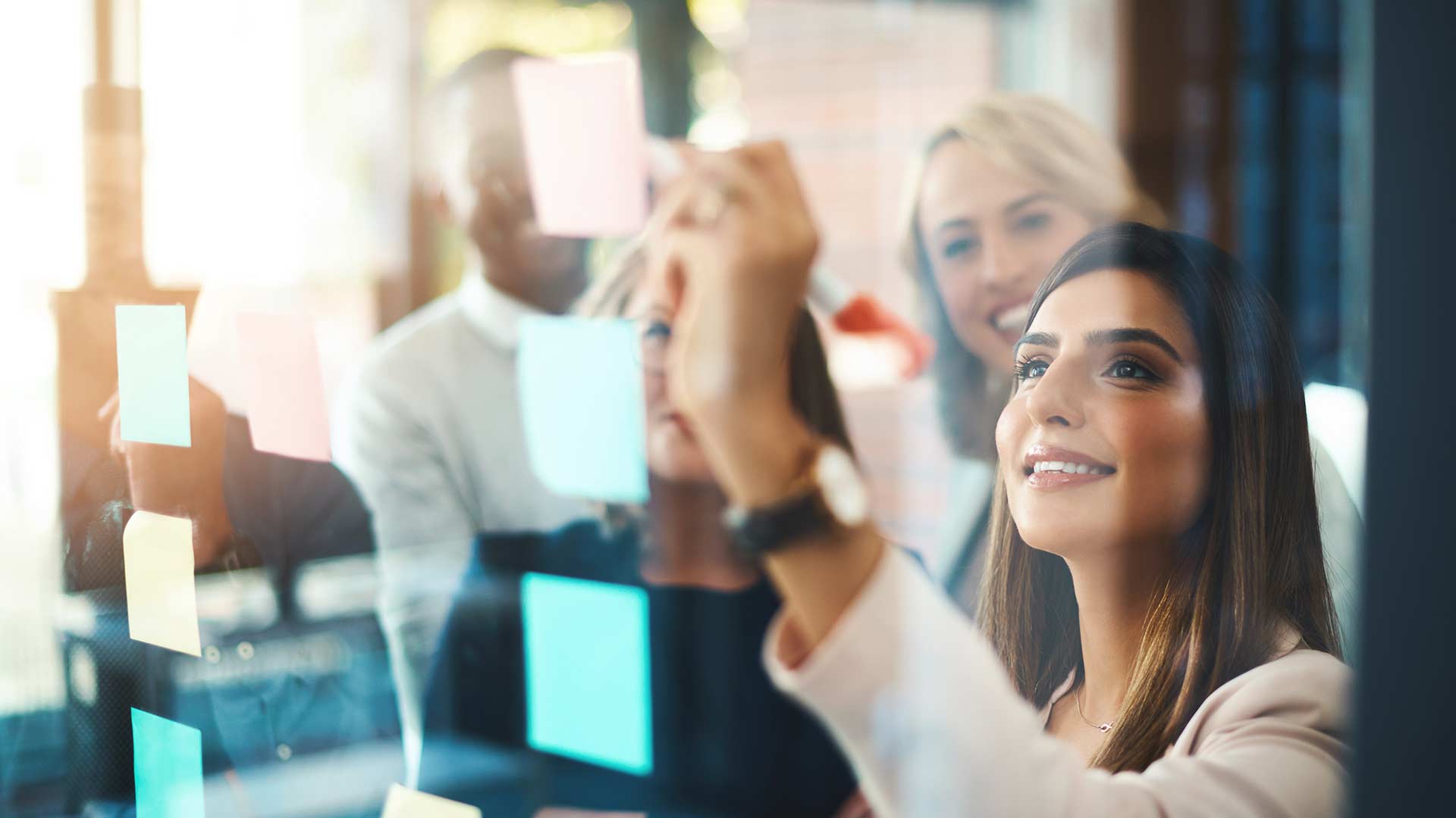 Woman working with a team to solve a problem