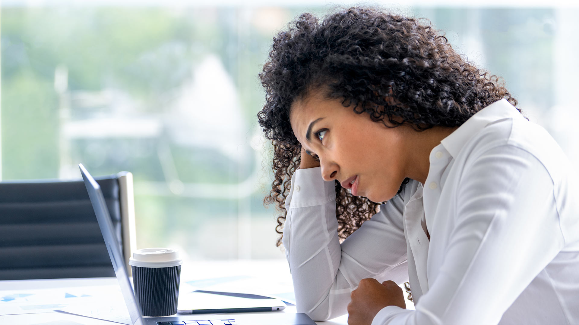 Woman looking frustrated at laptop