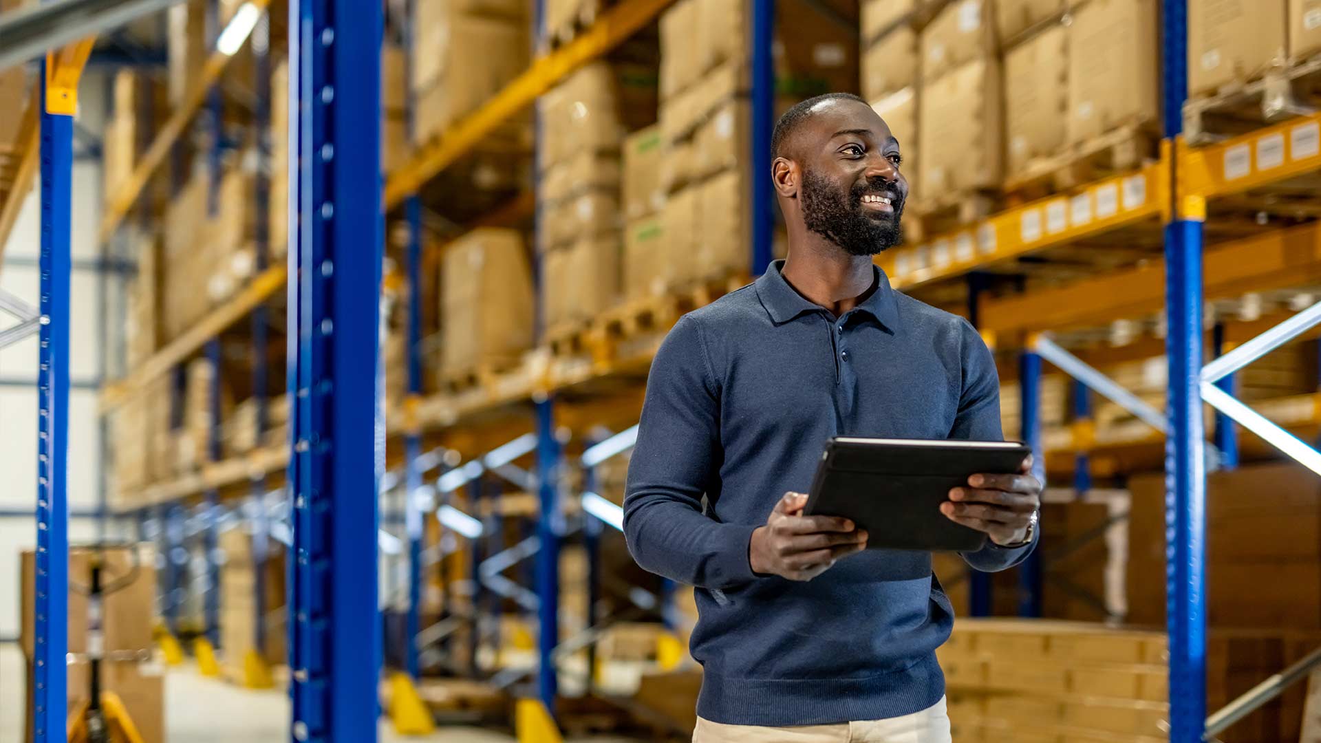 Man in warehouse on using a tablet